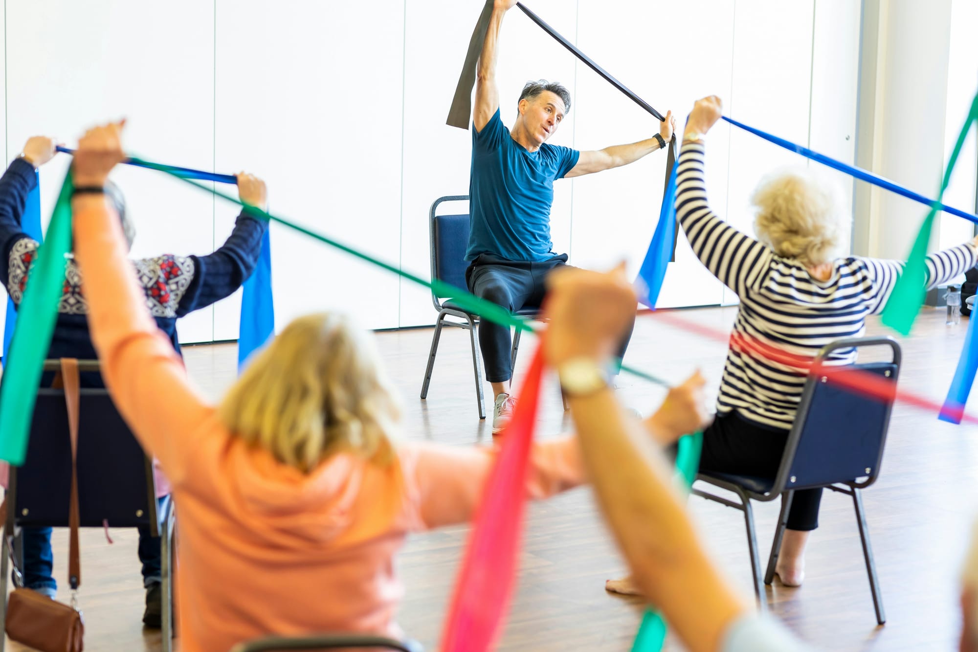 Older adults using resistance bands in a group fitness class