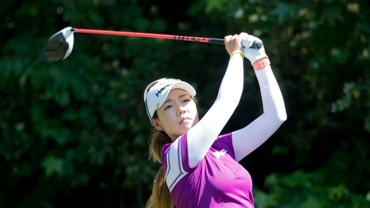 Jenny Shin follows through on a driver swing during a past LPGA event; she shares the Round 1 lead at the women's Scottish Open.