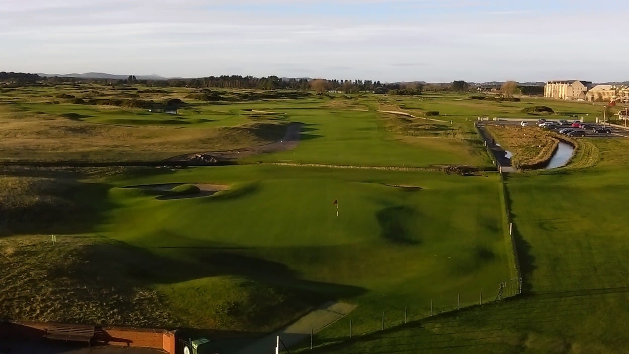 Elevated view of the 18th green on Carnoustie's Championship Course, with the Barry Burn crossing the fairway in front of it